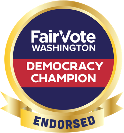 a circular badge with a gold ribbon border. The text in the middle reads "FairVote Washington Democracy Champion" and along the ribbon at the bottom is the the word "ENDORSED" in solid block letters.